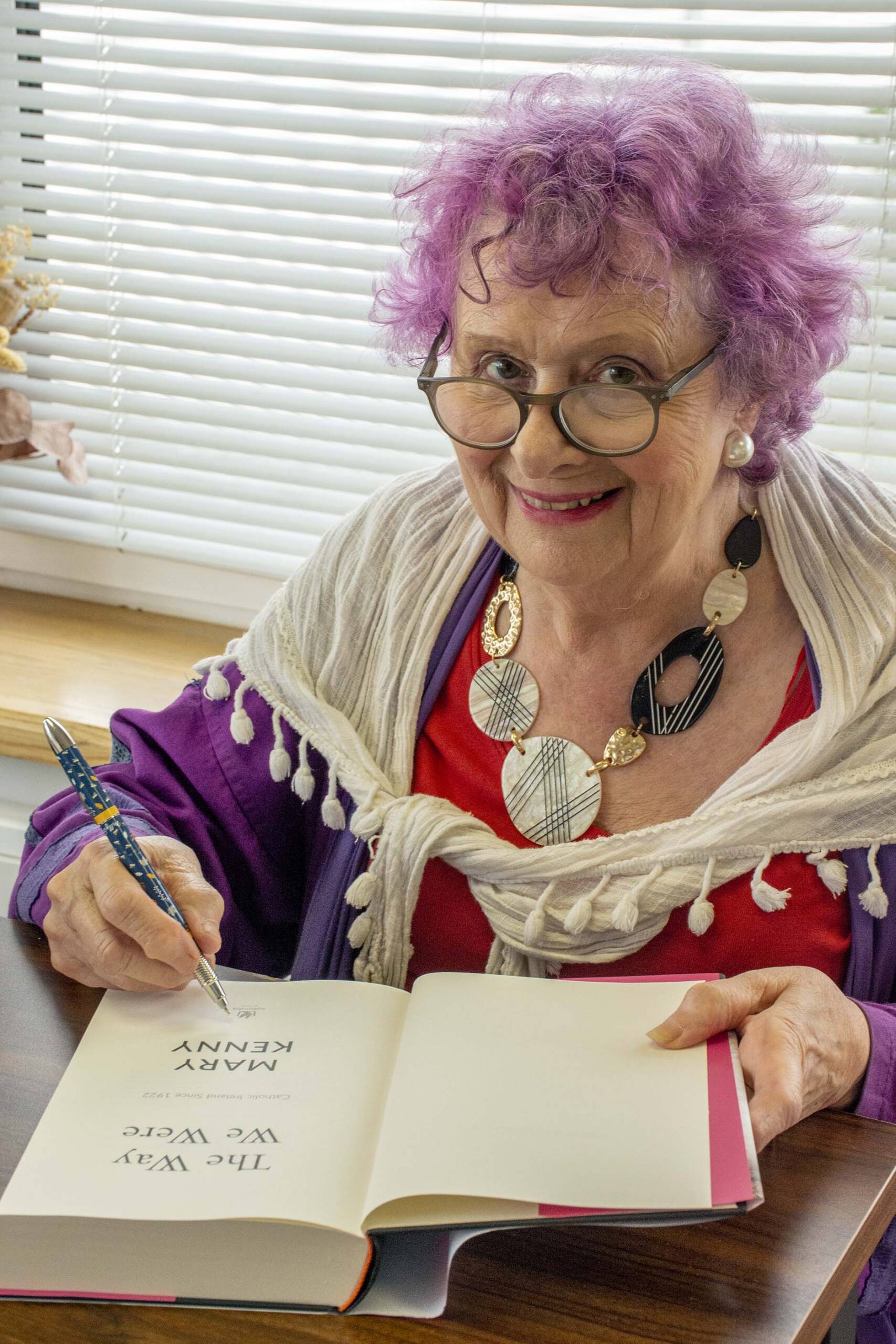 Mary Kenny vertical portrait shot signing twww